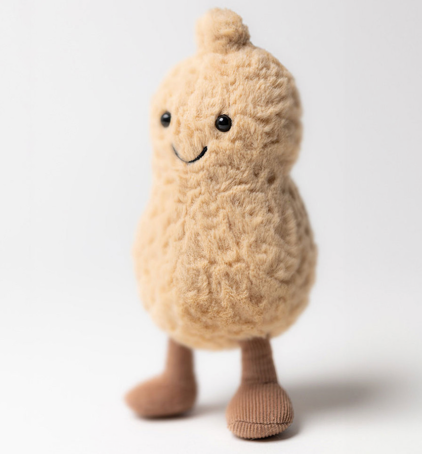 Standing Peanut Jellycat plush toy shaped like a peanut with a smiling face on a white background
