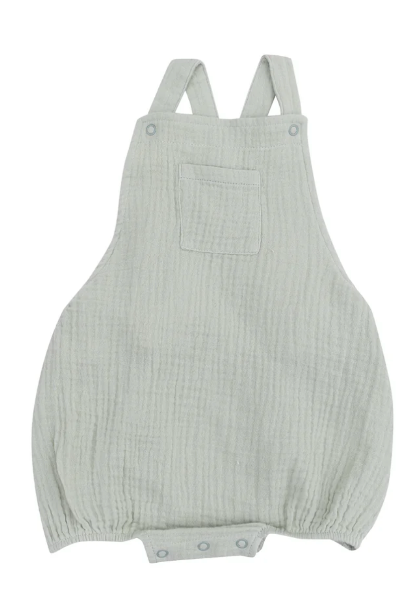 Desert green muslin Pocket Sunsuit for babies featuring a chest pocket and easy snap closures.