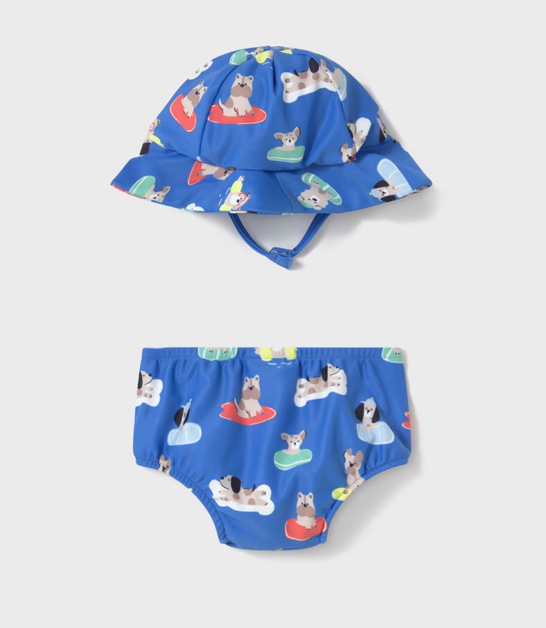 Blue children's sun hat and swim diaper set with dog pattern on a white background