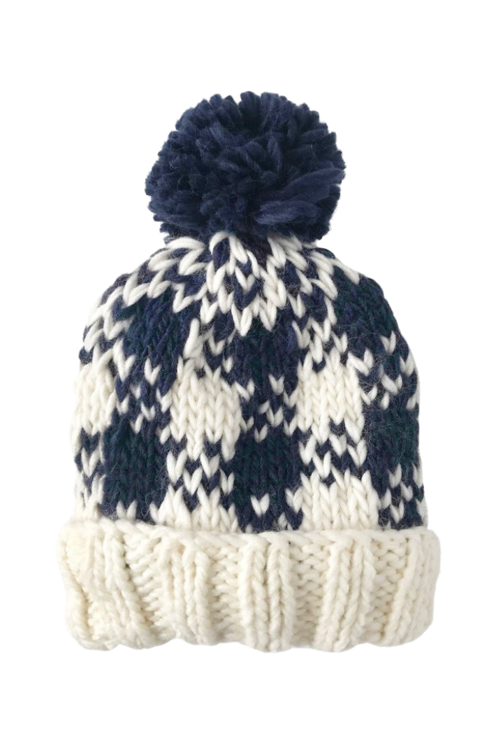 A baby Blueberry Hill beanie with a buffalo check pattern in cream and navy colors with a soft brim.