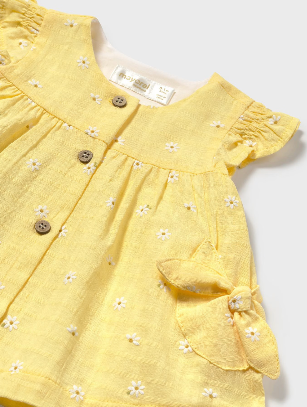 Close up of Daisy print on sunny baby dress