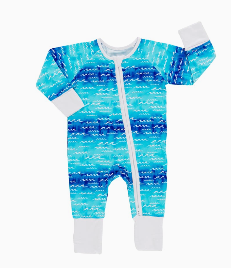 A pair of baby coveralls with long sleeves, footless design, and a vertical zipper in the middle. The fabric appears soft with a blue and white geometric pattern.
