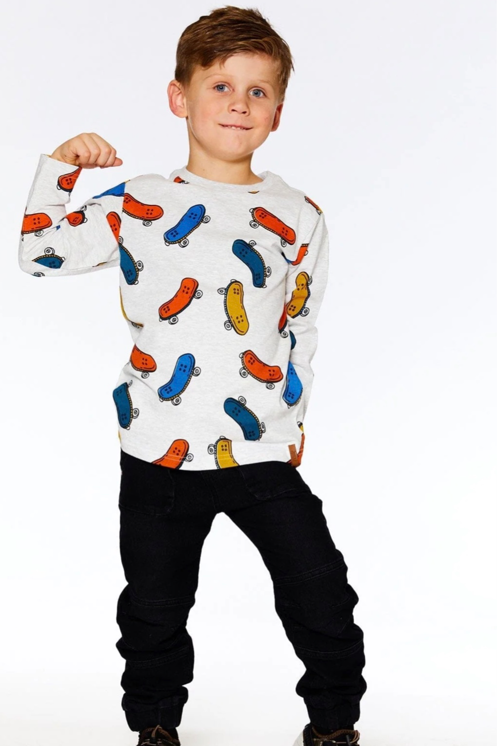 Boy wearing Deux Par Deux twill jogger pants with skateboard shirt