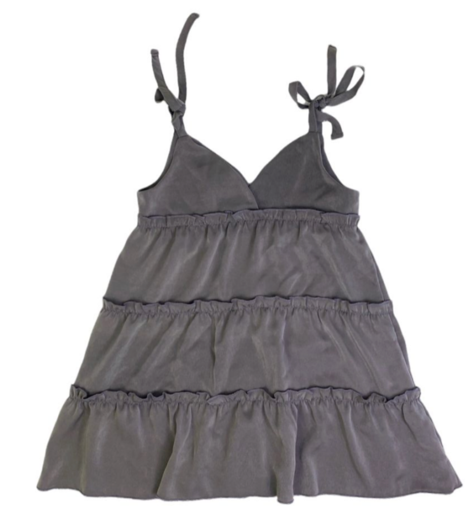 Gray tiered dress with tied straps on a white background