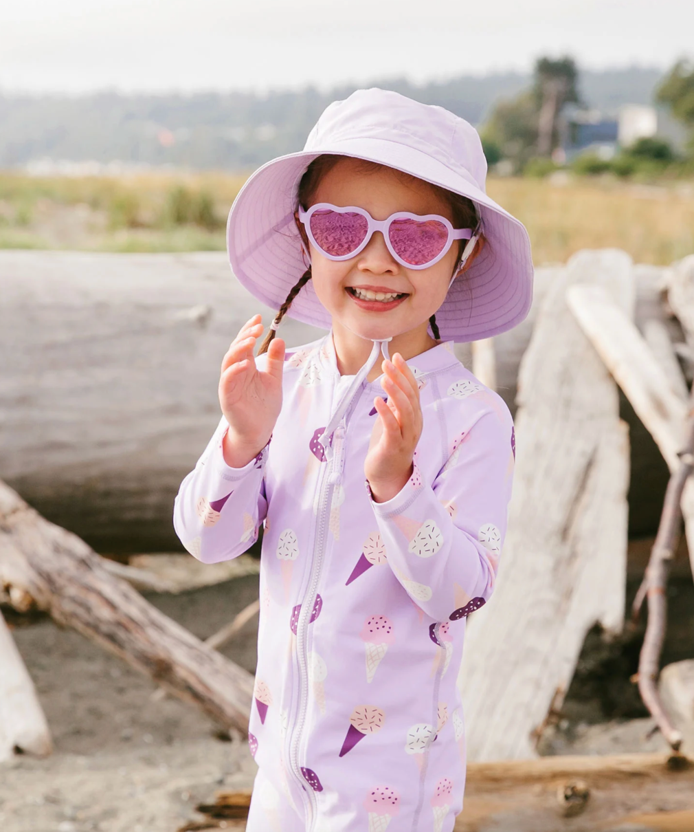 Girl wearing a Jan & Jul bucket hat in lavender