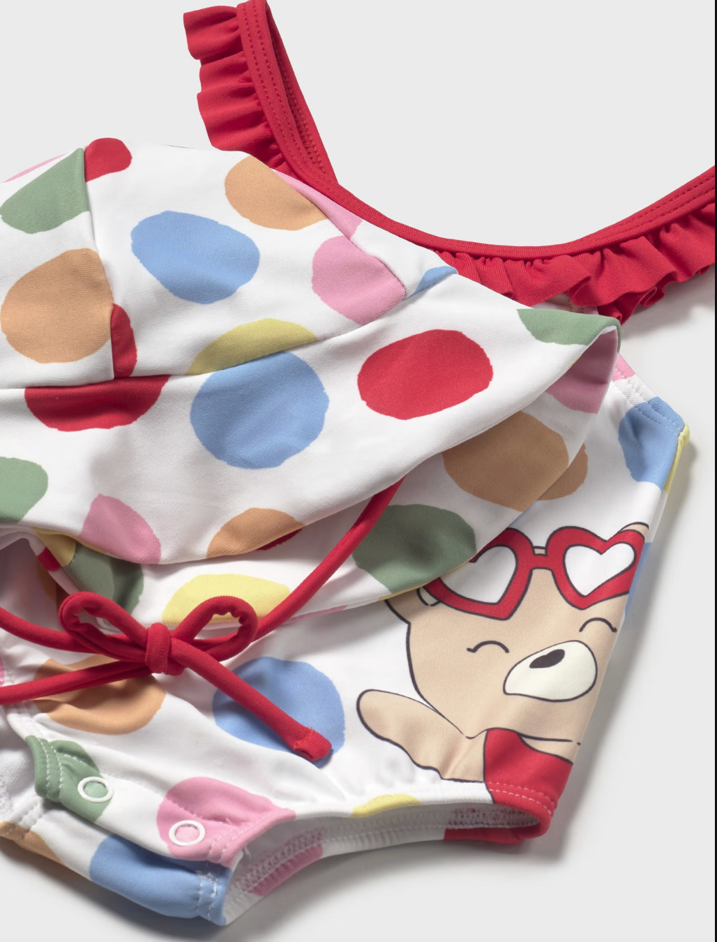 Close up view of Mayoral swim set with hat and one-piece suit.
