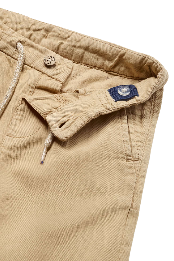 Close up of Linen pants with drawstring and button.
