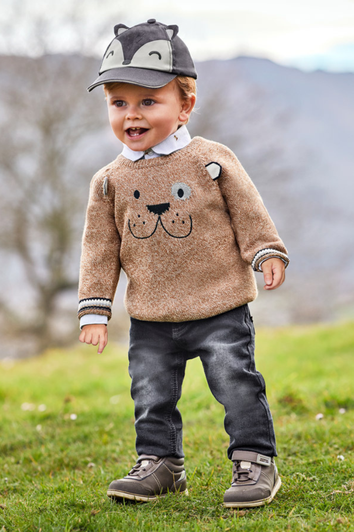Little boy wearing Mayoral Off Black jeans with puppy sweater and hat.