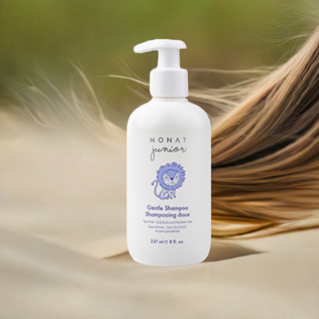 Bottle of Monat junior gentle shampoo with long hair in the background