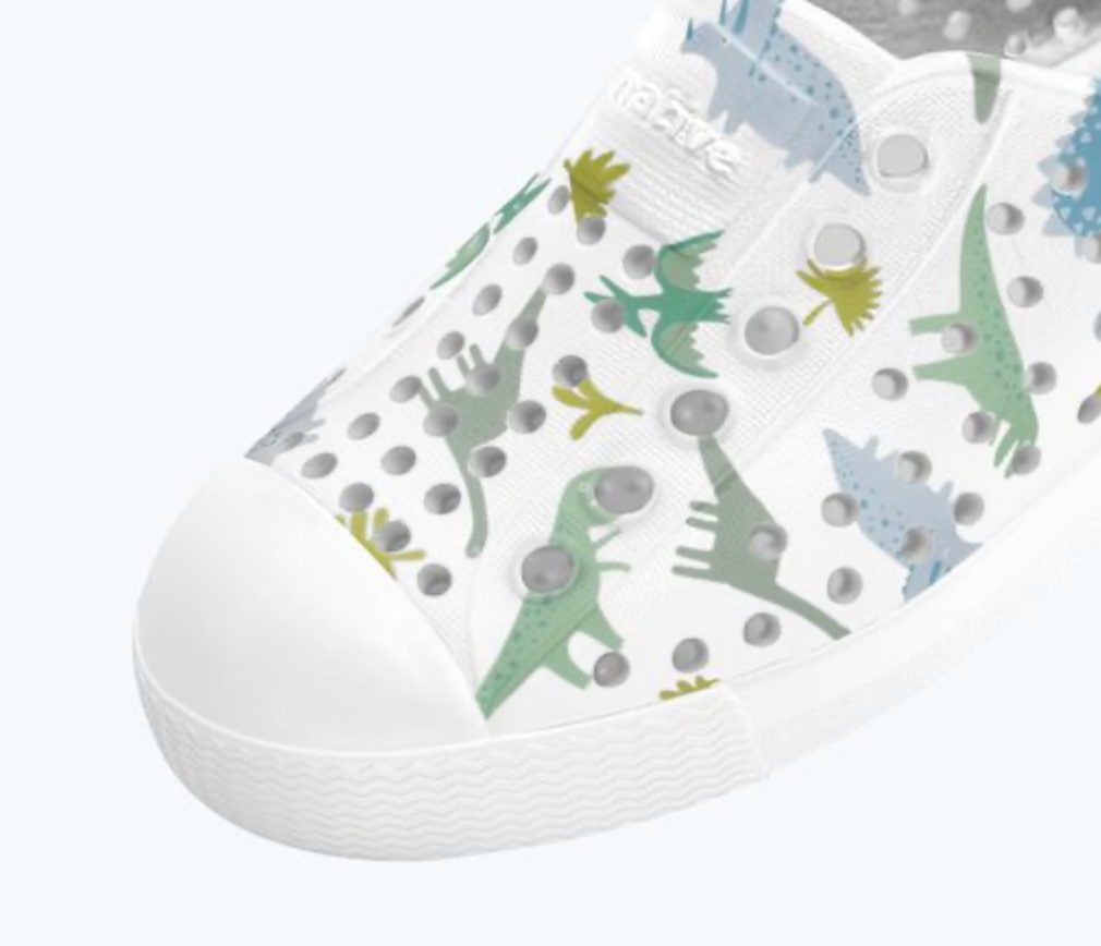 White sneaker with dinosaur pattern on a white background