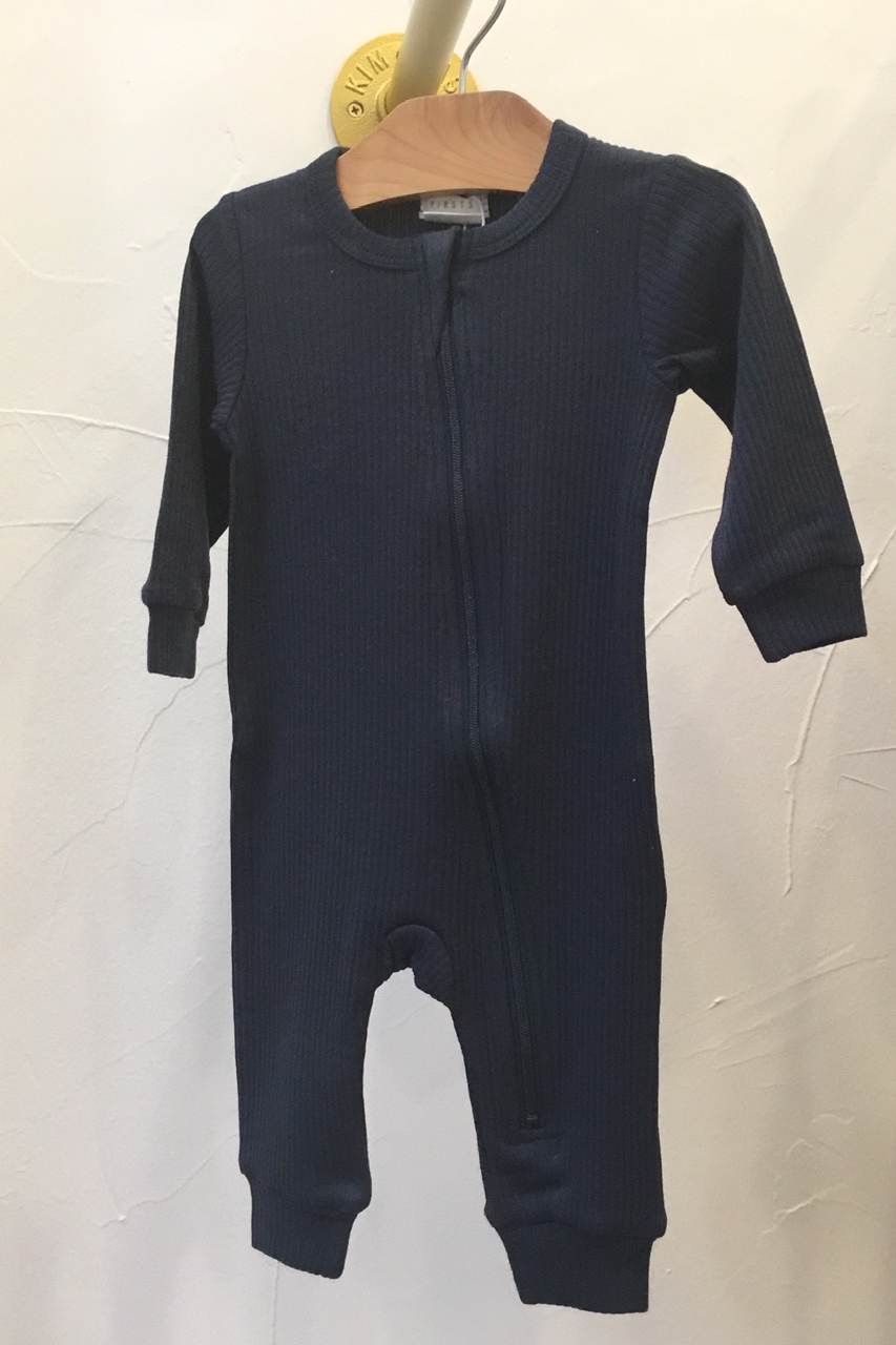 A blue one-piece pyjama for babies, with a visible zipper and a wooden hanger at the top.