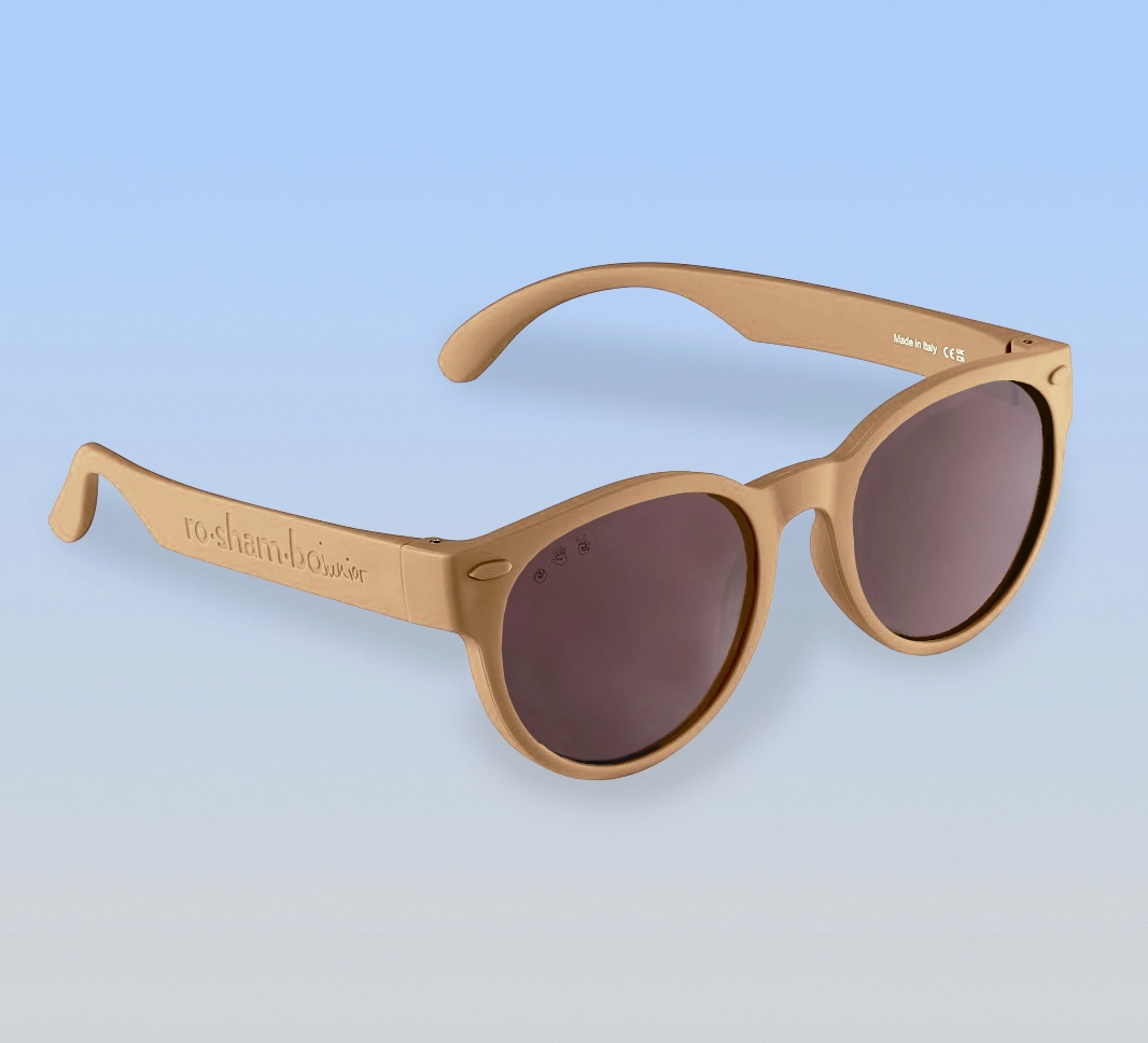 Ro Sham Bo latte sunglasses with dark lenses on a light blue background
