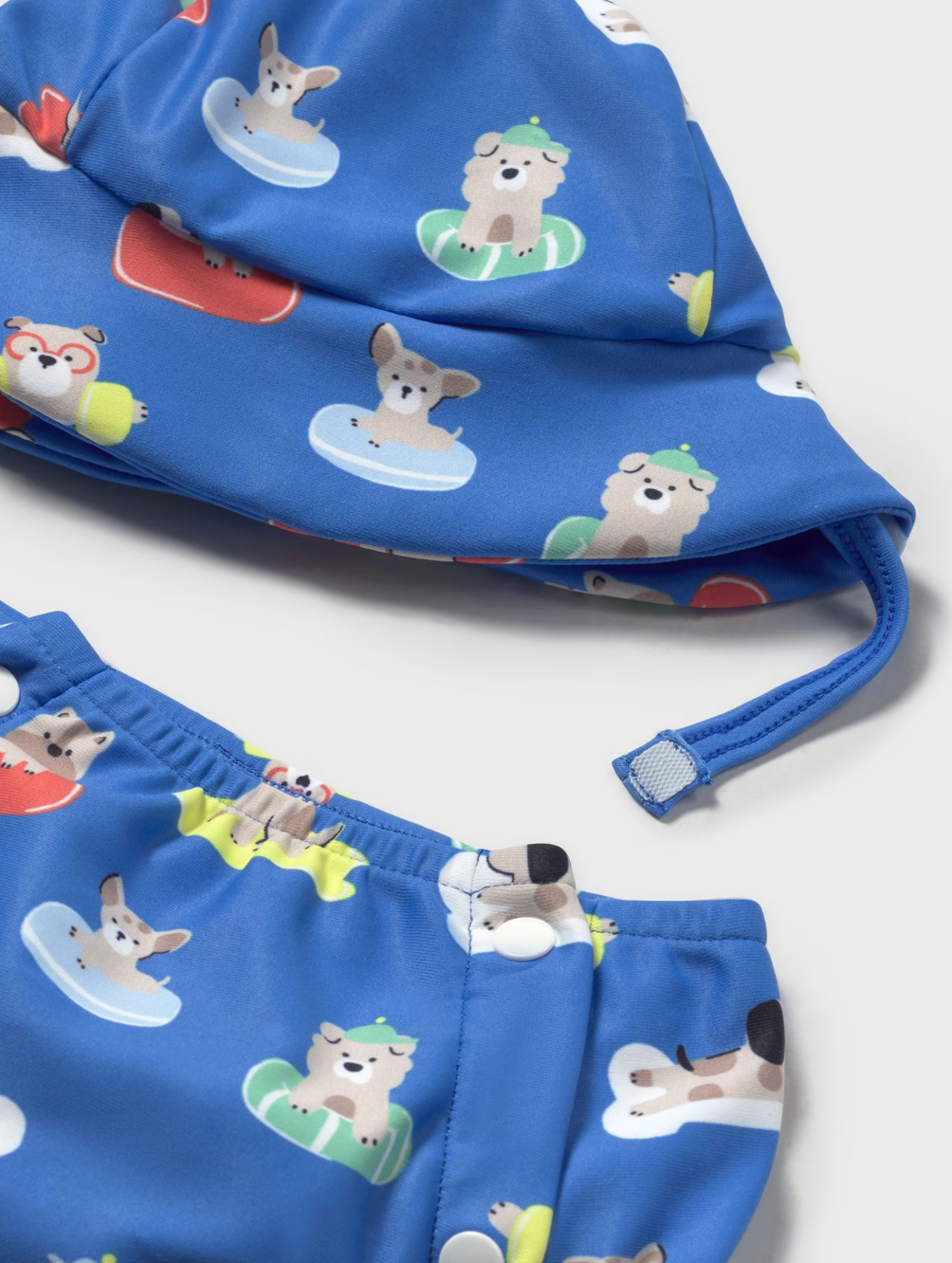 Blue swim trunks with animal prints on a white background