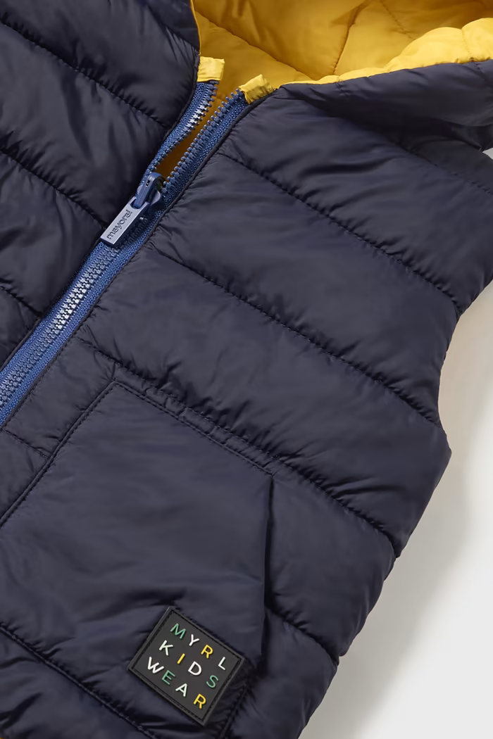 Close up of Unisex Mayoral blue and yellow reversible vest