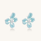 Turquoise blue enamel flower earrings with crystal centers and gold-plated brass posts on white background.