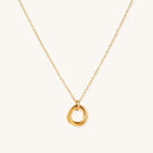 Close-up of a gold-plated stainless steel necklace with interlocking twisted ring pendant on white background