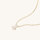 Delicate gold butterfly necklace with white mother of pearl wings on fine chain, displayed on neutral background.