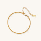 Delicate 18K gold plated stainless steel chain bracelet with textured links and adjustable extender on neutral background.