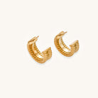 Close-up of 14K gold plated textured hoop earrings with rope pattern against cream background showing convertible design