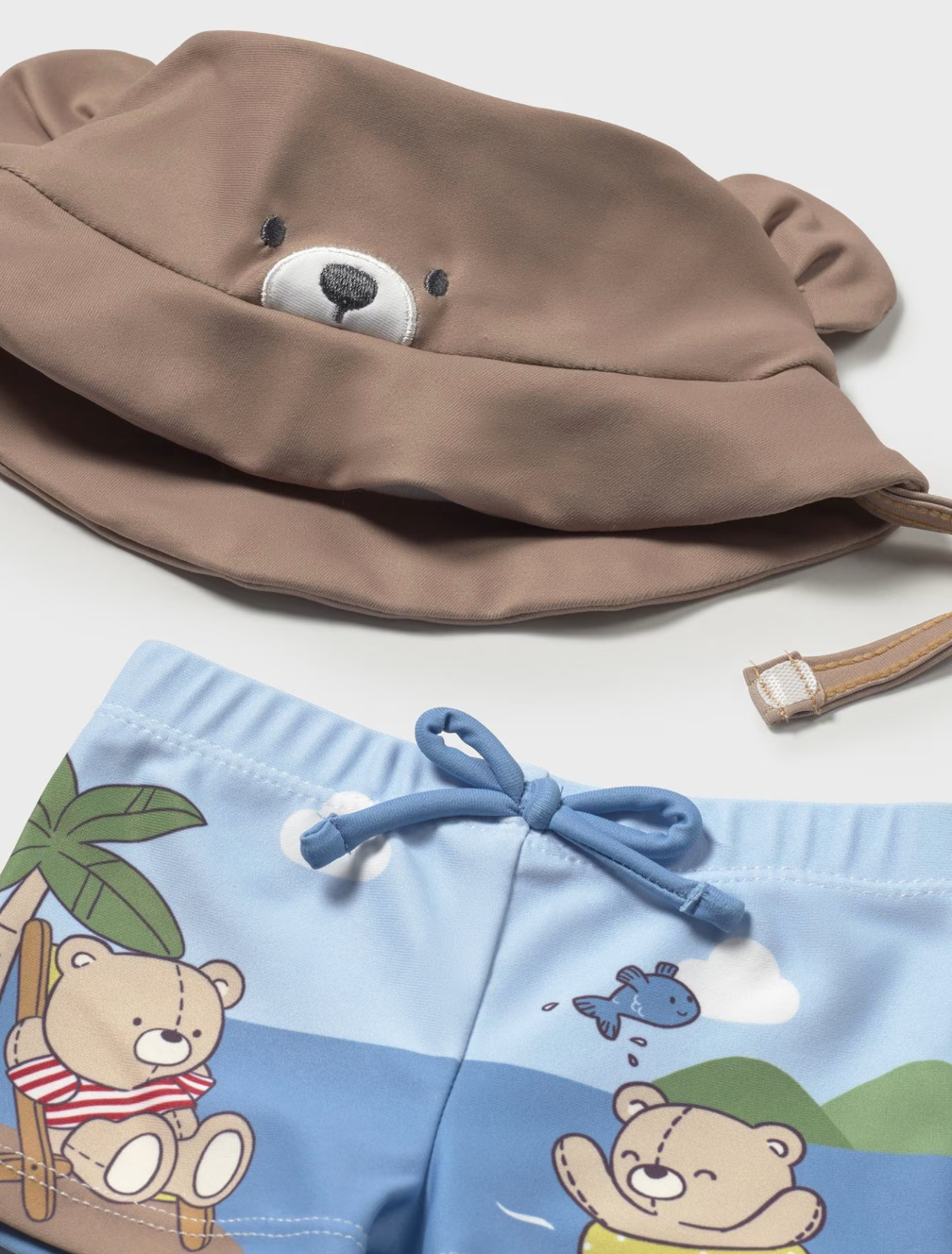 Close of the hat and shorts of the 3-piece baby swim set with bears on it.