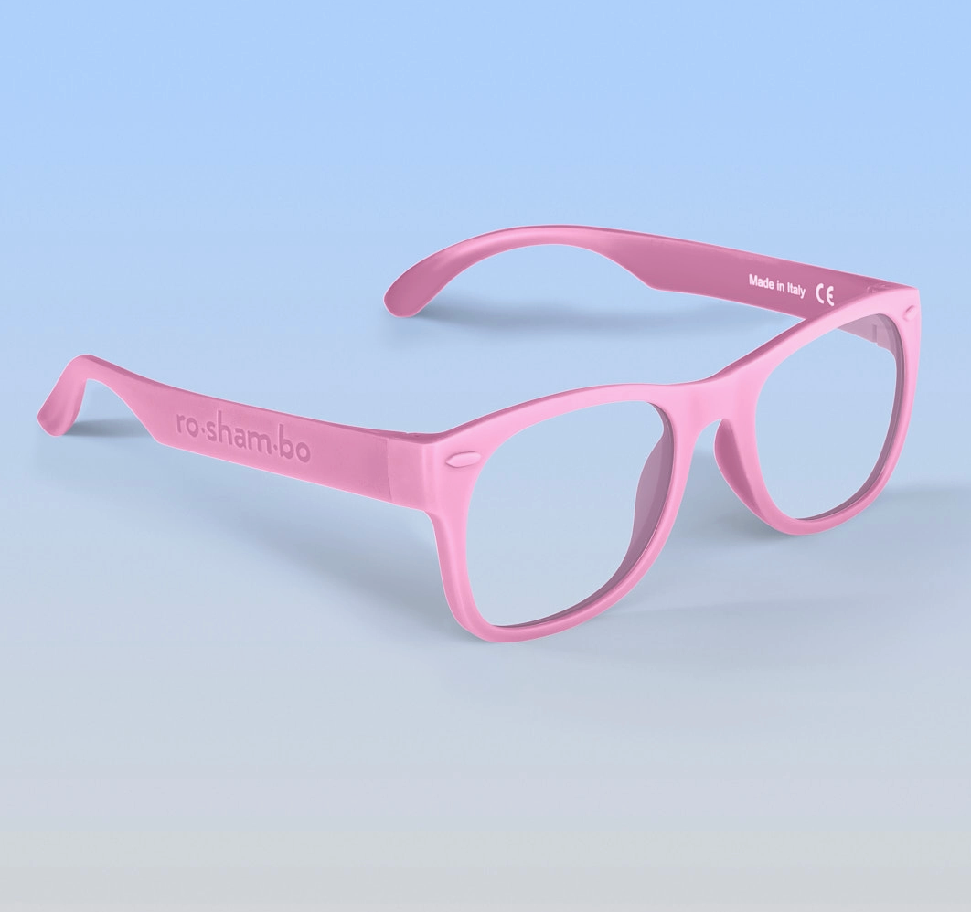 Pink eyeglasses with 'ro sham bo' branding for blue light protection. 
