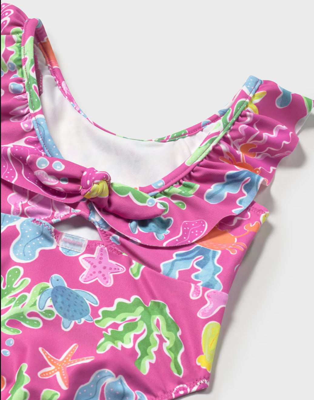 Close up view of front of Mayoral pink swim suit.