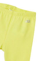 Close up view of Mayoral yellow capri pants with logo