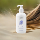 Bottle of Monat junior gentle shampoo with long hair in the background