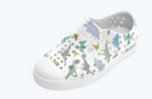White clog shoe with dinosaur pattern on a white background