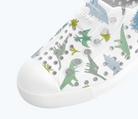 White sneaker with dinosaur pattern on a white background
