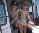 Boys getting their feet cleaned with Shakalolife sandscreen.