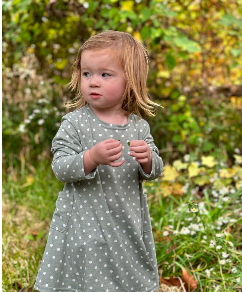 Little girl in Vignette sage green dress with white polkadots